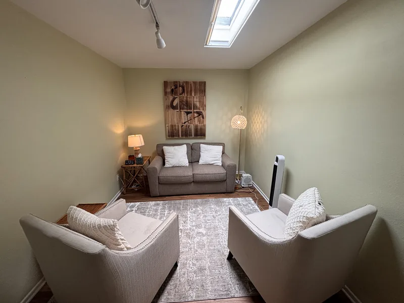 Daylit waiting room with a skylight, armchairs and a sofa at the Third Street Counseling office